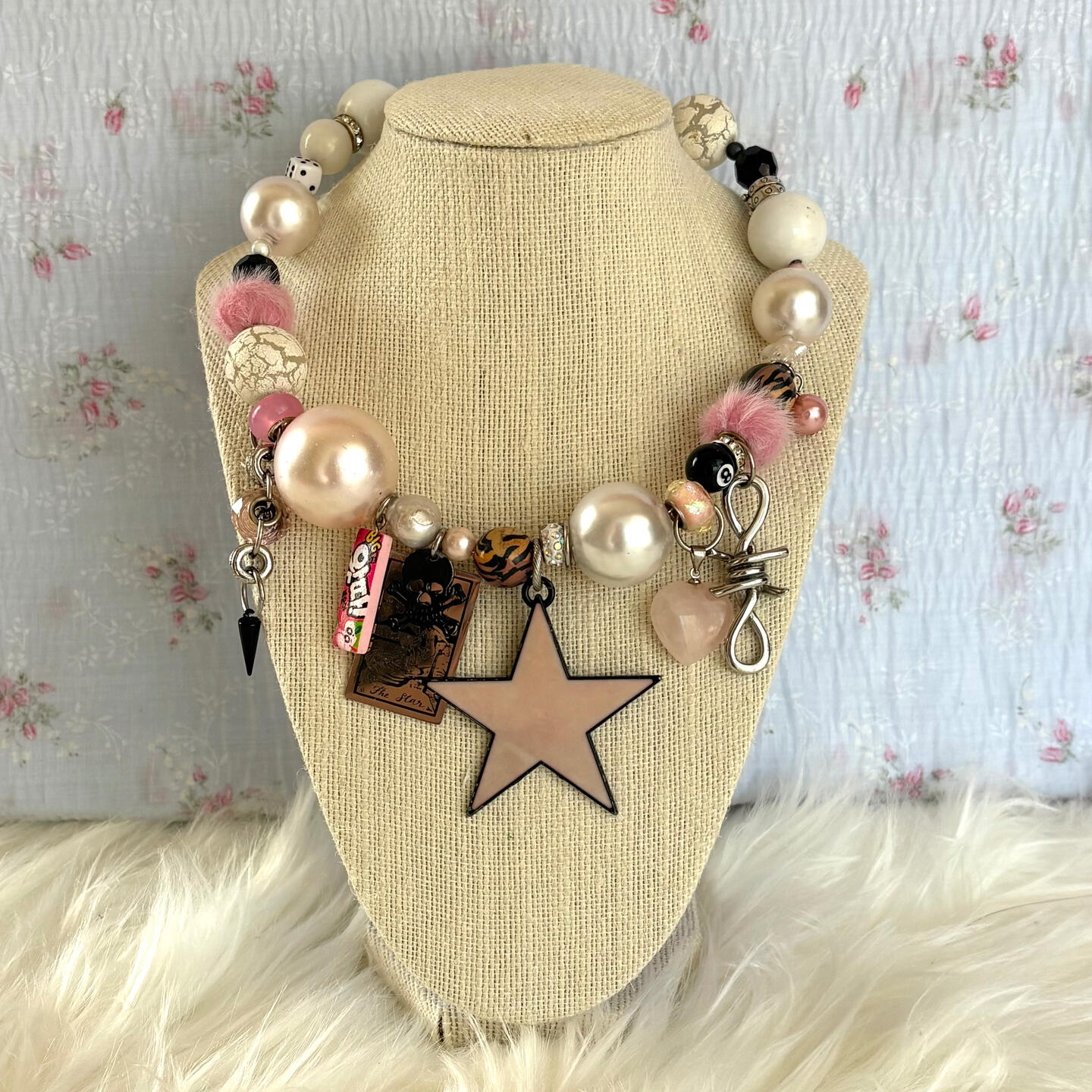 feel pretty all over with this stunning statement necklace; highlights include a faux fur bead, tarot card charm, oversized faux pearls, star shaped fresh water pearls, a barbed wire charm, vintage pendant centrepiece, and stainless steel hardware.