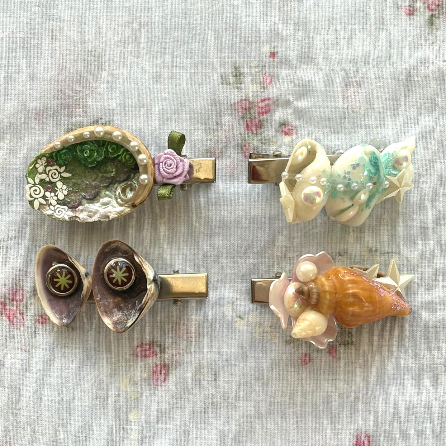 wear them close enough to your ear, and you’re bound to hear the ocean. these unique clips are constructed using treasures of all kinds, including consciously sourced/secondhand seashells, stickers, lace + woven appliqué, acrylic embellishments and more.